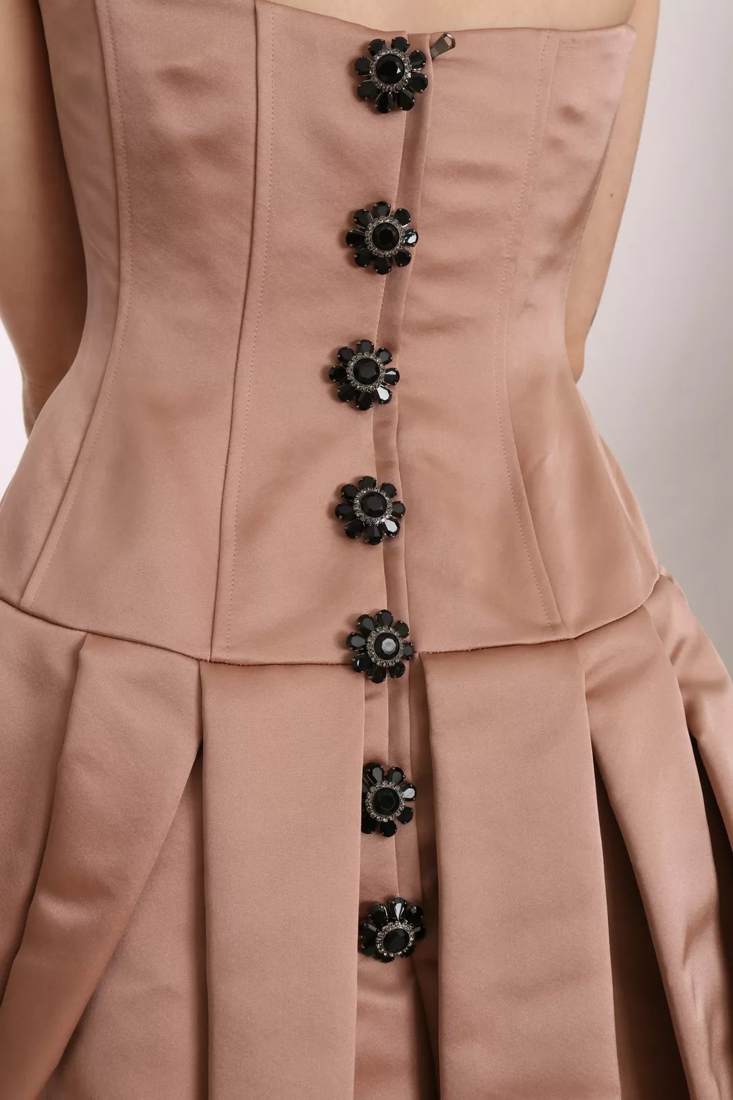 A pink chandelier ball gown dress with black crystals on the bodice