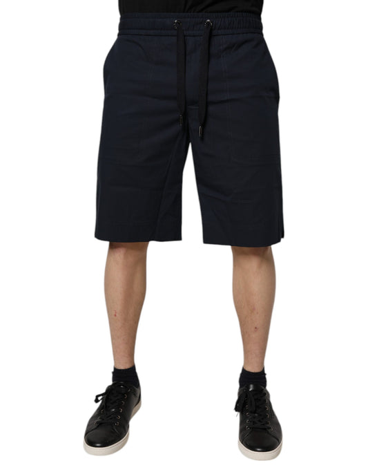 A pair of dark blue cotton bermuda shorts with an elastic waistband