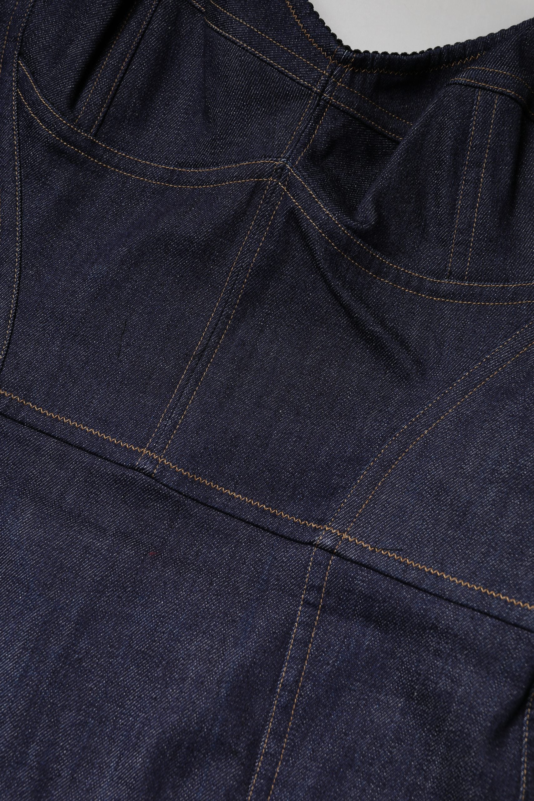 A dark blue denim sheath midi dress with a buttoned front and visible stitching