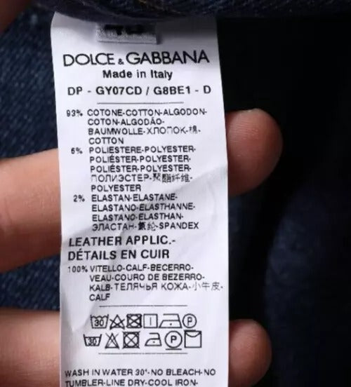 Tag on clothing item indicating brand, material, care instructions, and country of manufacture