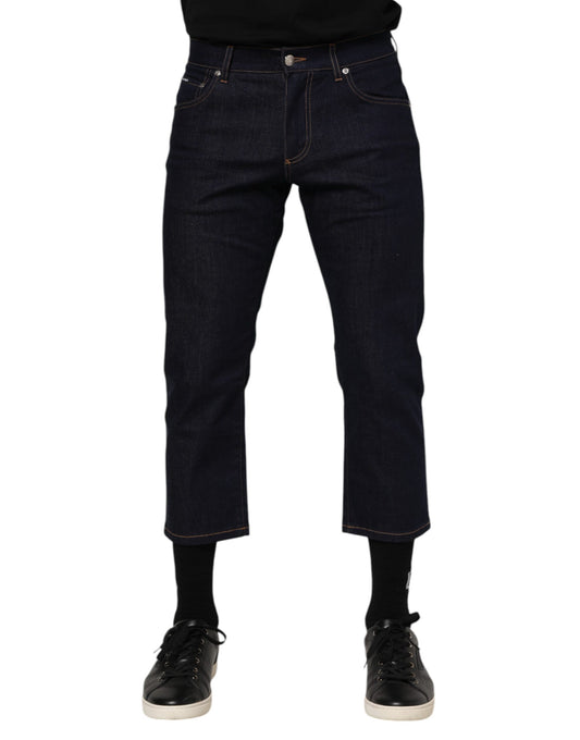 Pair of blue denim jeans with rolled up legs