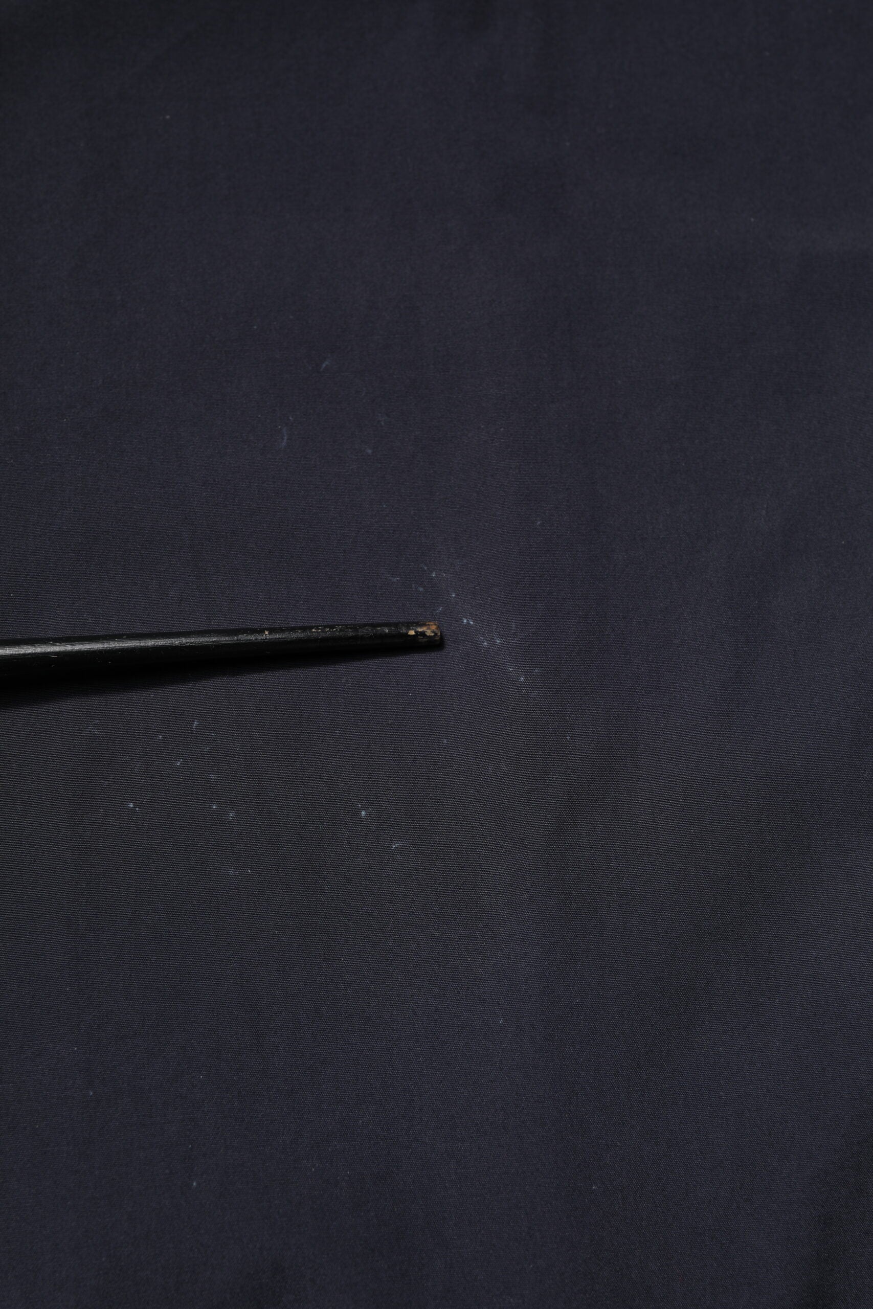 Black fabric with a hole in it