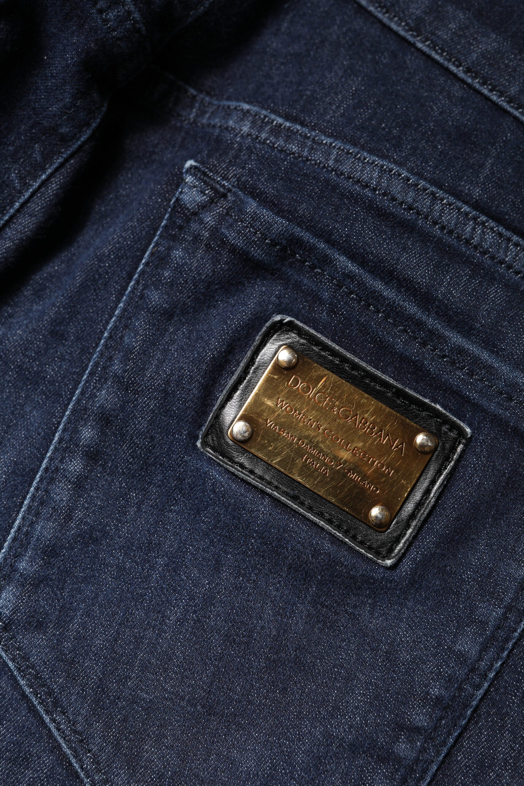 Blue denim jeans with a branded label on the back pocket