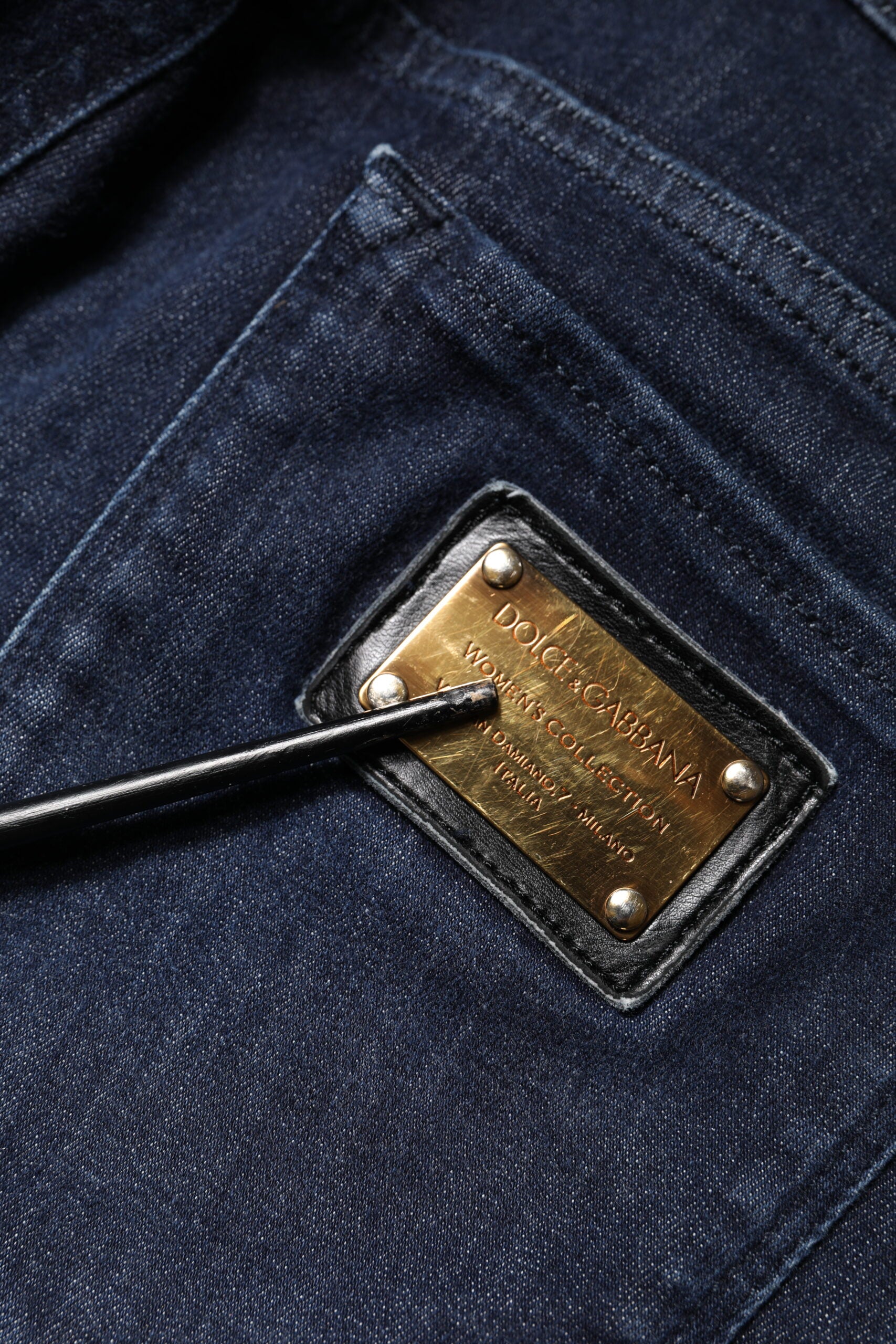 Blue jeans with a gold label on the front pocket