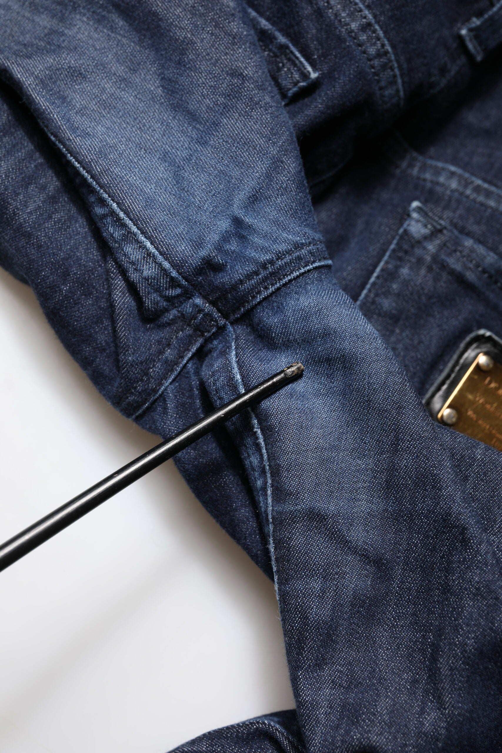 Blue denim jeans on a white surface