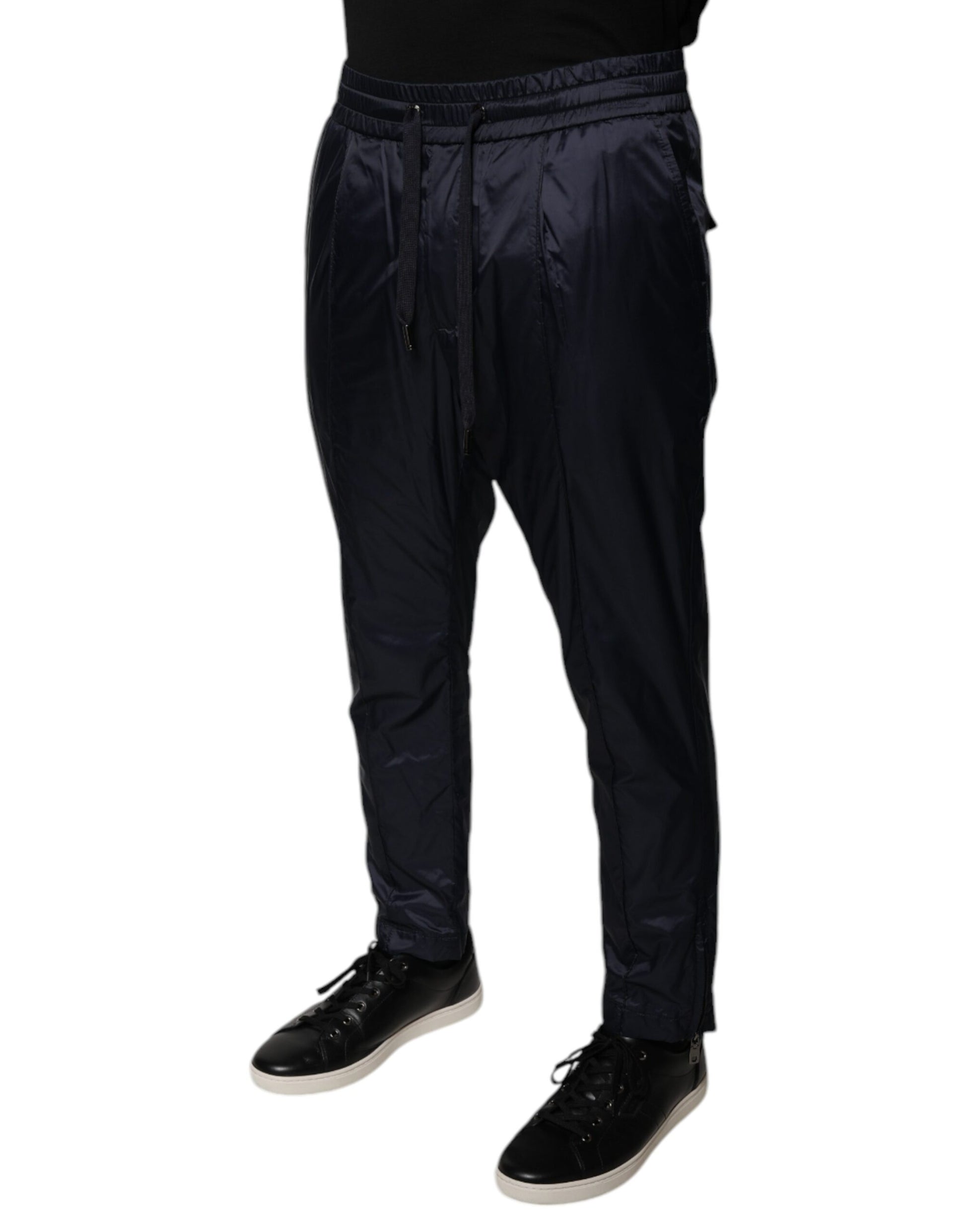 Man wearing black pants and white shoes