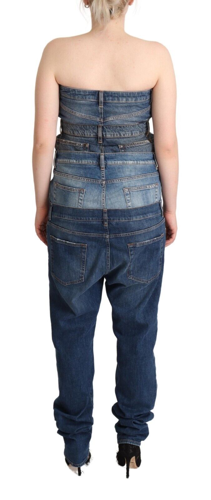 A woman wearing a dark blue denim jumpsuit dress with no straps