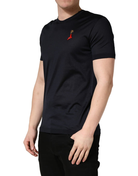 Man wearing dark blue t-shirt with red ribbon design on front