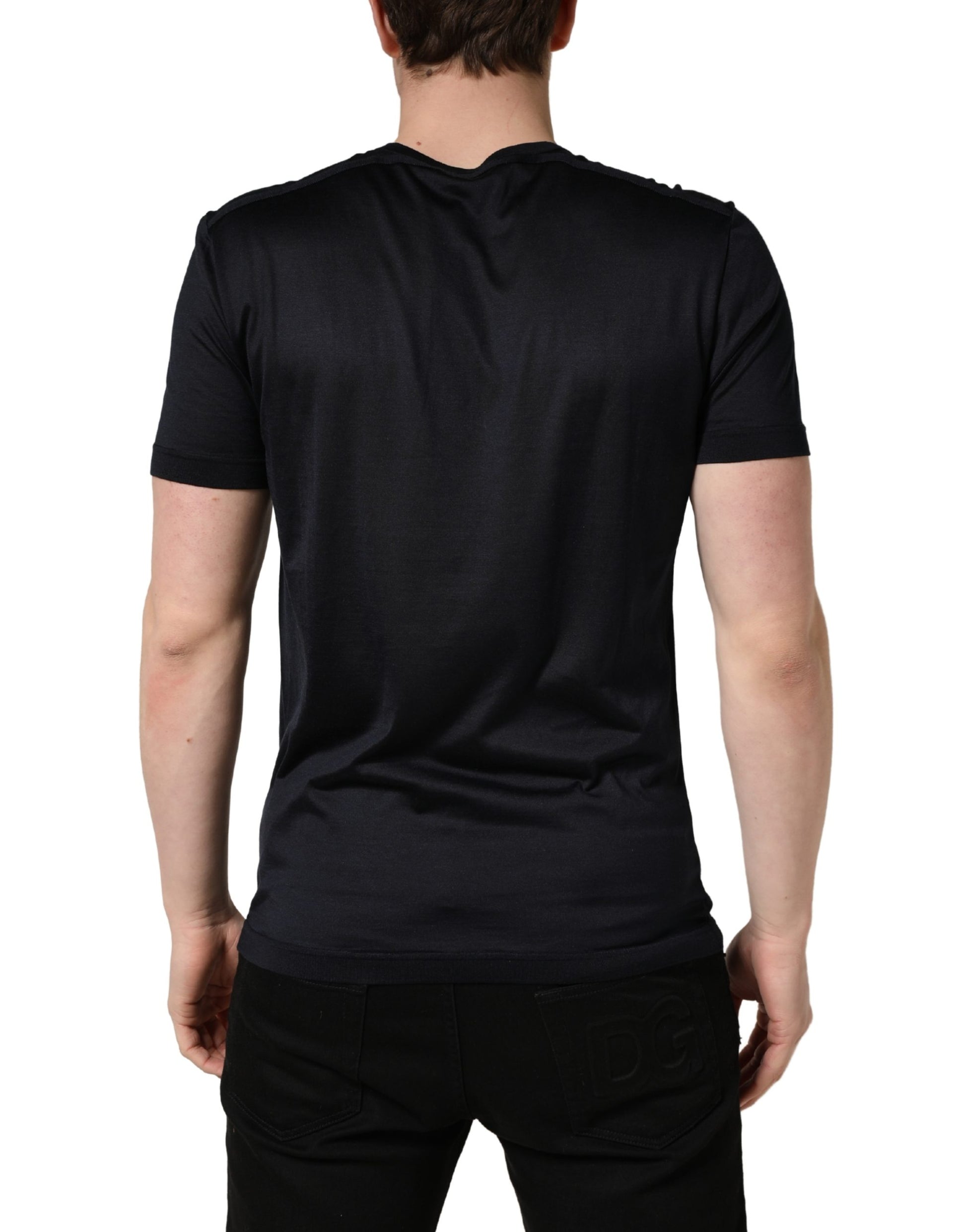 Black short sleeve shirt on a man's back