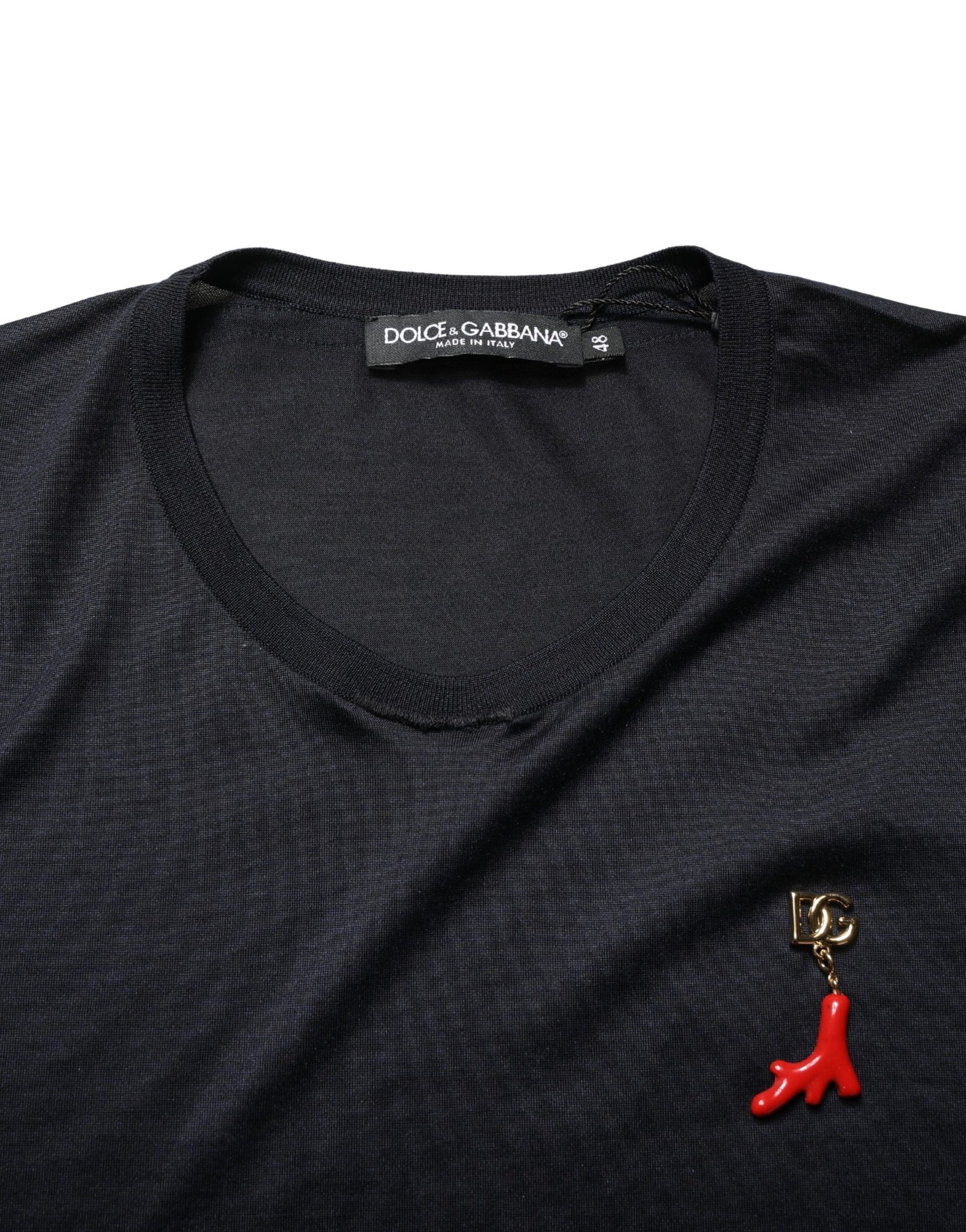 Black shirt with red pin on left chest area