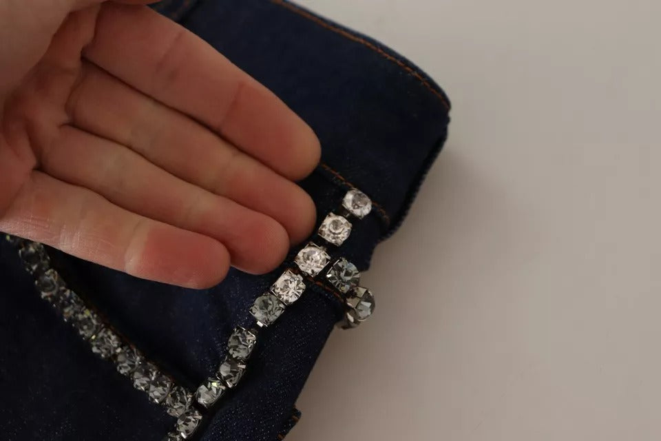 A pair of dark blue denim shorts with embellishments, featuring a silver chain and crystals
