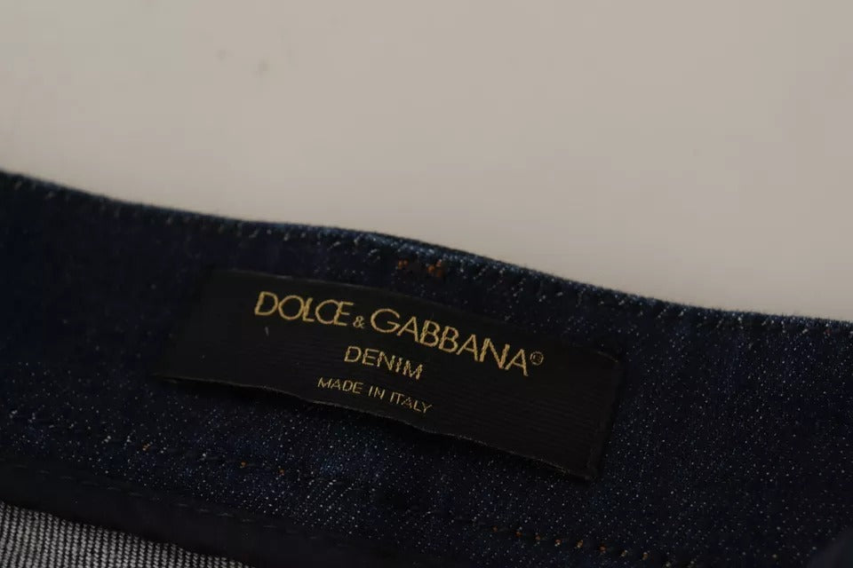 A pair of dark blue denim shorts with embellishments from the brand Dolce & Gabbana
