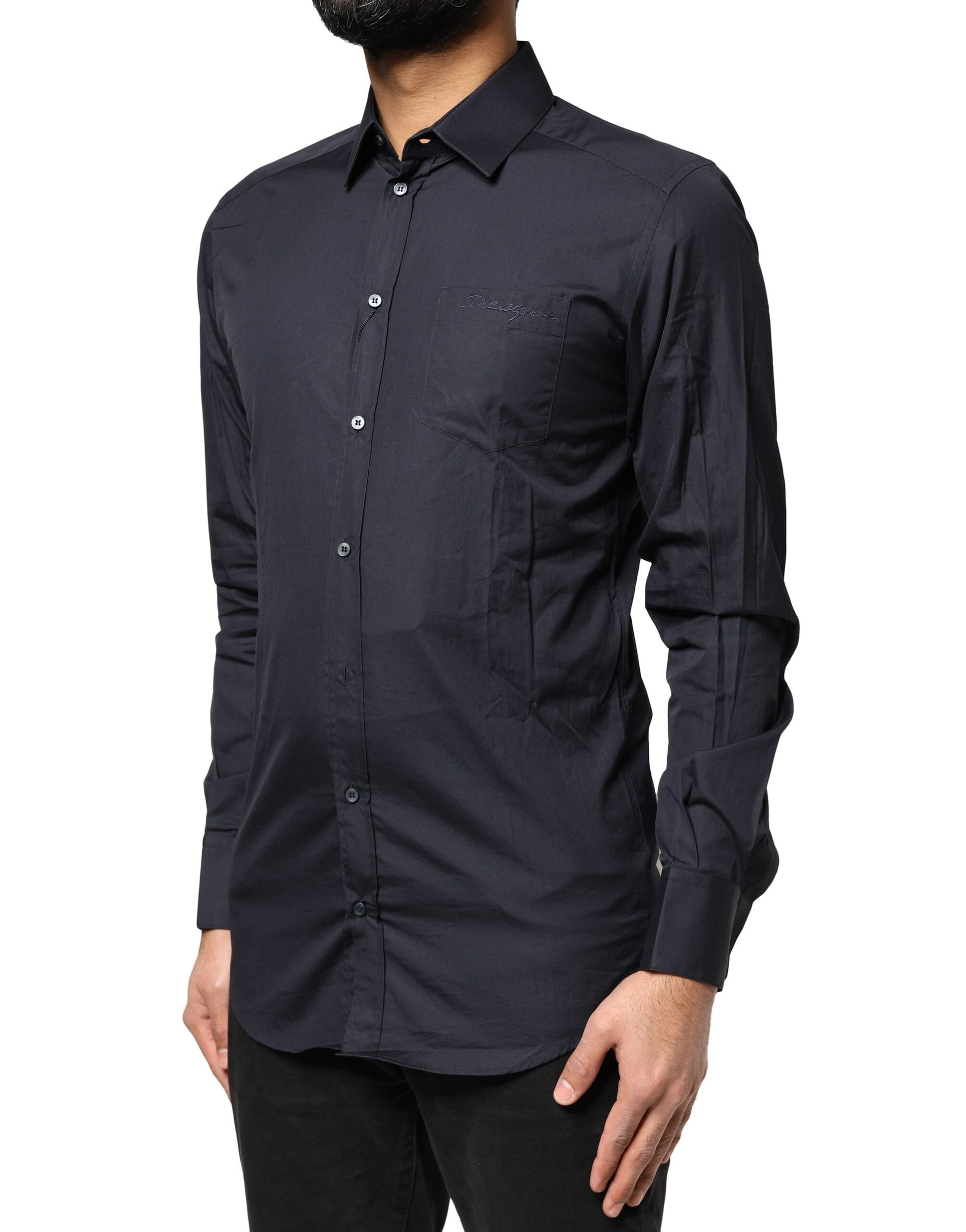 A dark blue long sleeve dress shirt with a gold emblem on the left chest