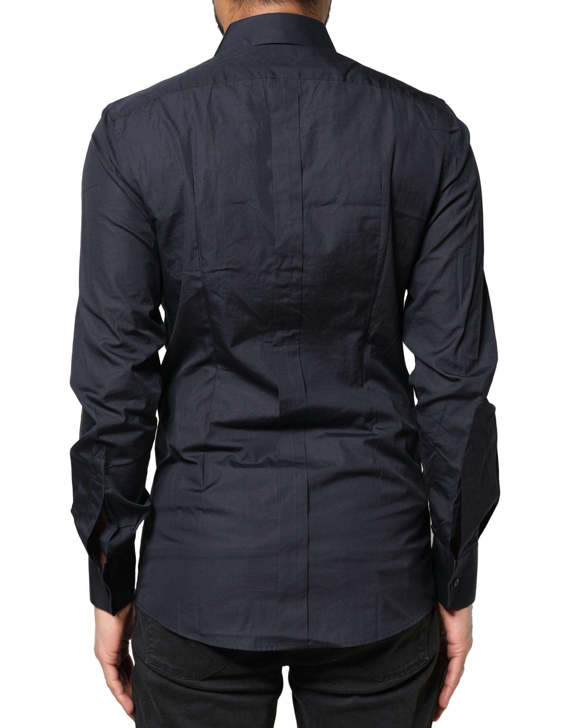 A dark blue dress shirt with long sleeves and gold accents