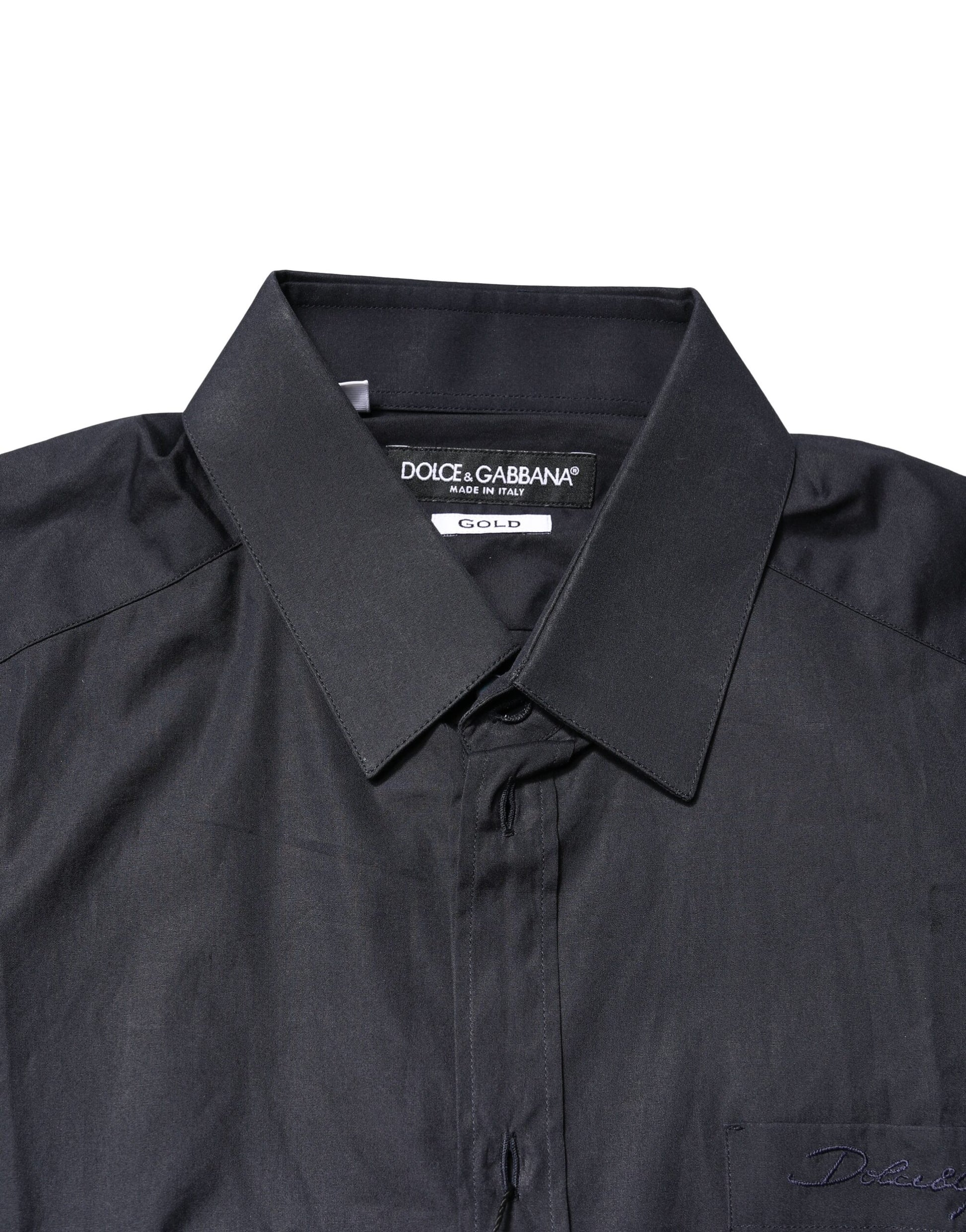 A dark blue dress shirt with long sleeves and gold accents, from the brand Dolce & Gabbana