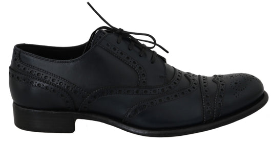 Pair of black dress shoes with laces and decorative stitching