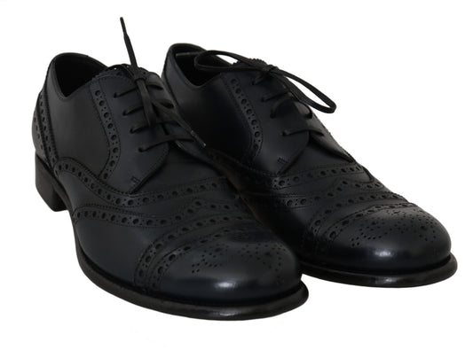 Pair of black leather shoes with laces and perforations