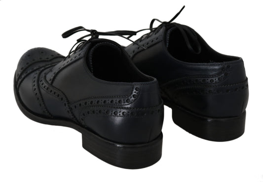 Pair of black dress shoes with laces and a bow tie design on top