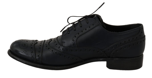 Pair of black dress shoes with laces and a bow tie
