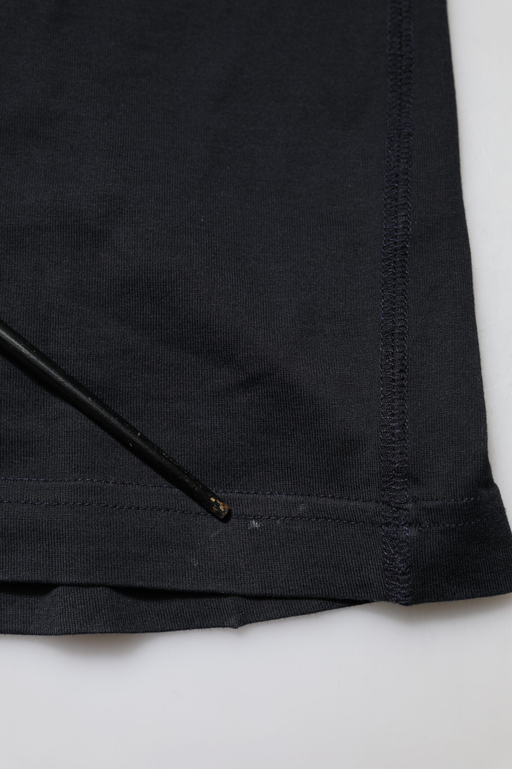 Black fabric with a small hole in the corner