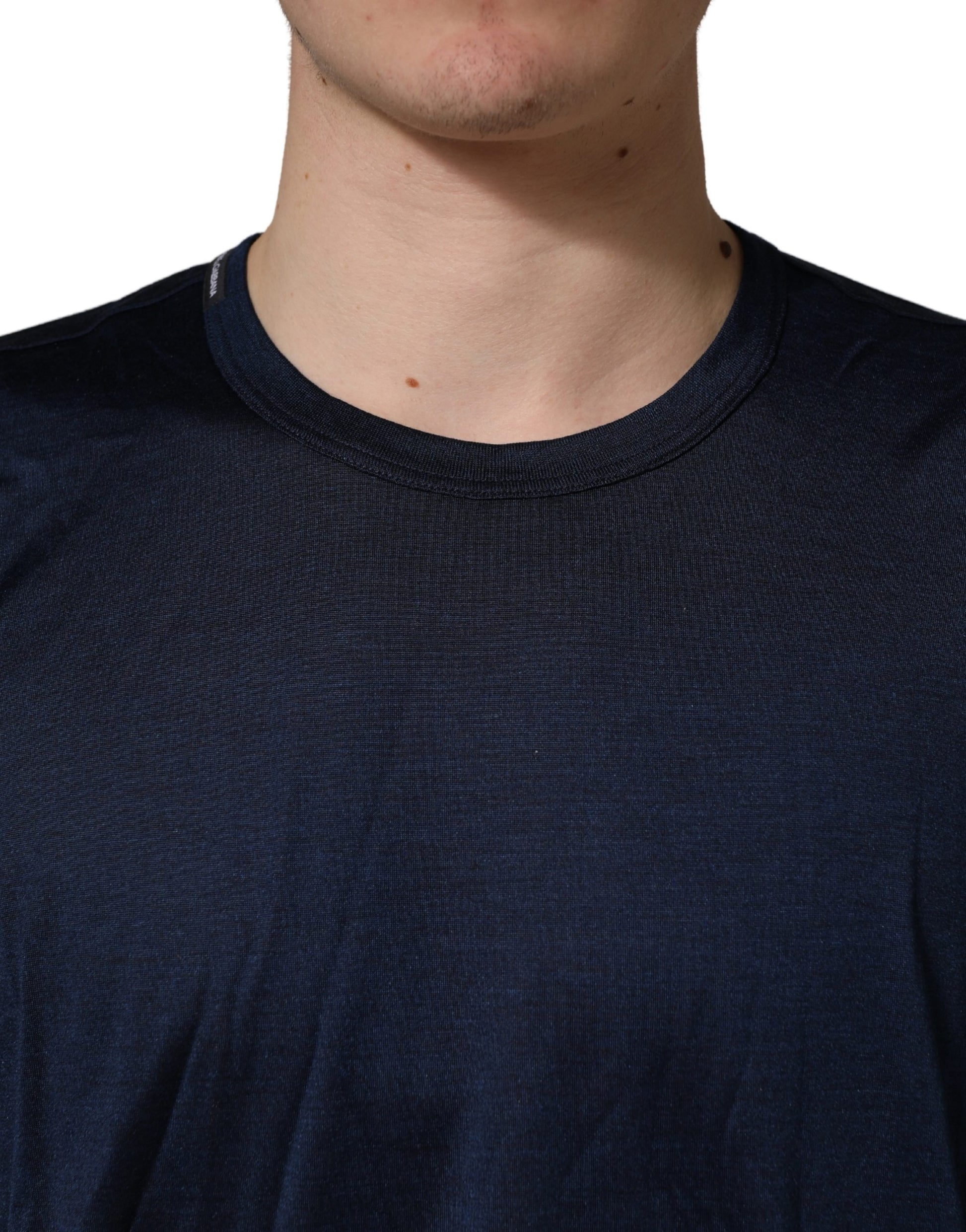 Man wearing dark blue athletic shirt