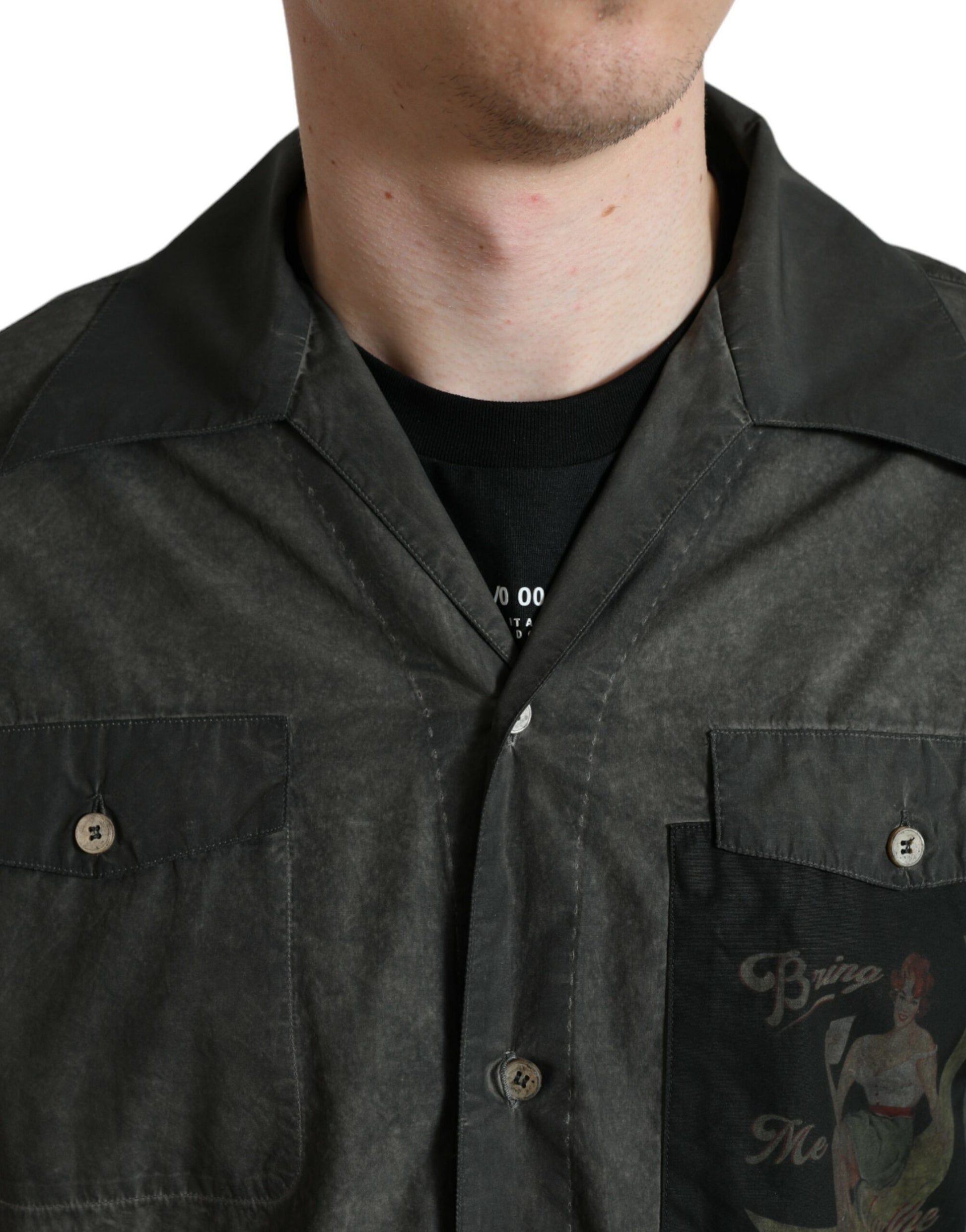 Man wearing a black jacket with a logo on the front