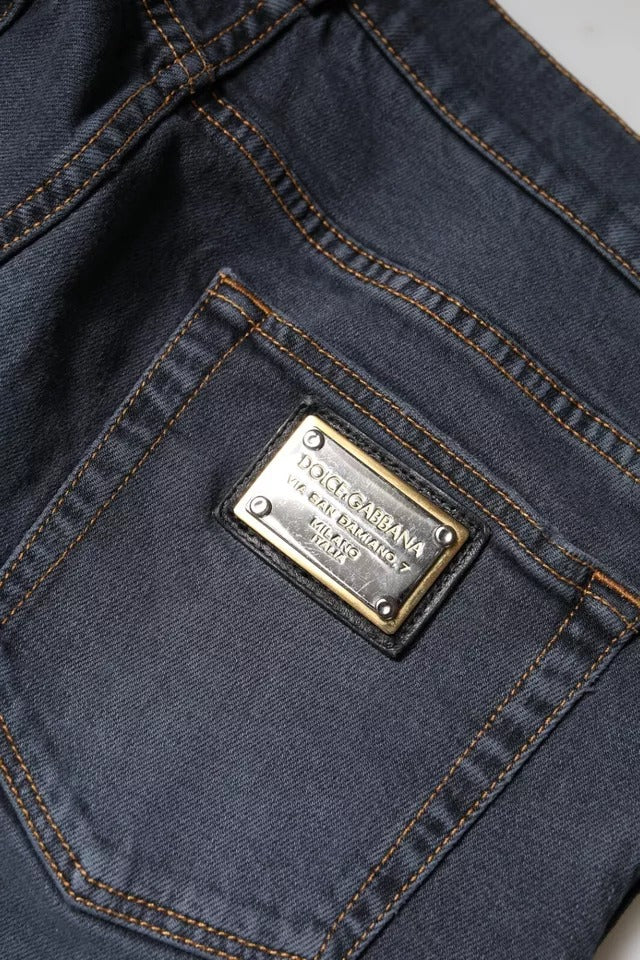 Blue jeans with a metal brand label on the front pocket