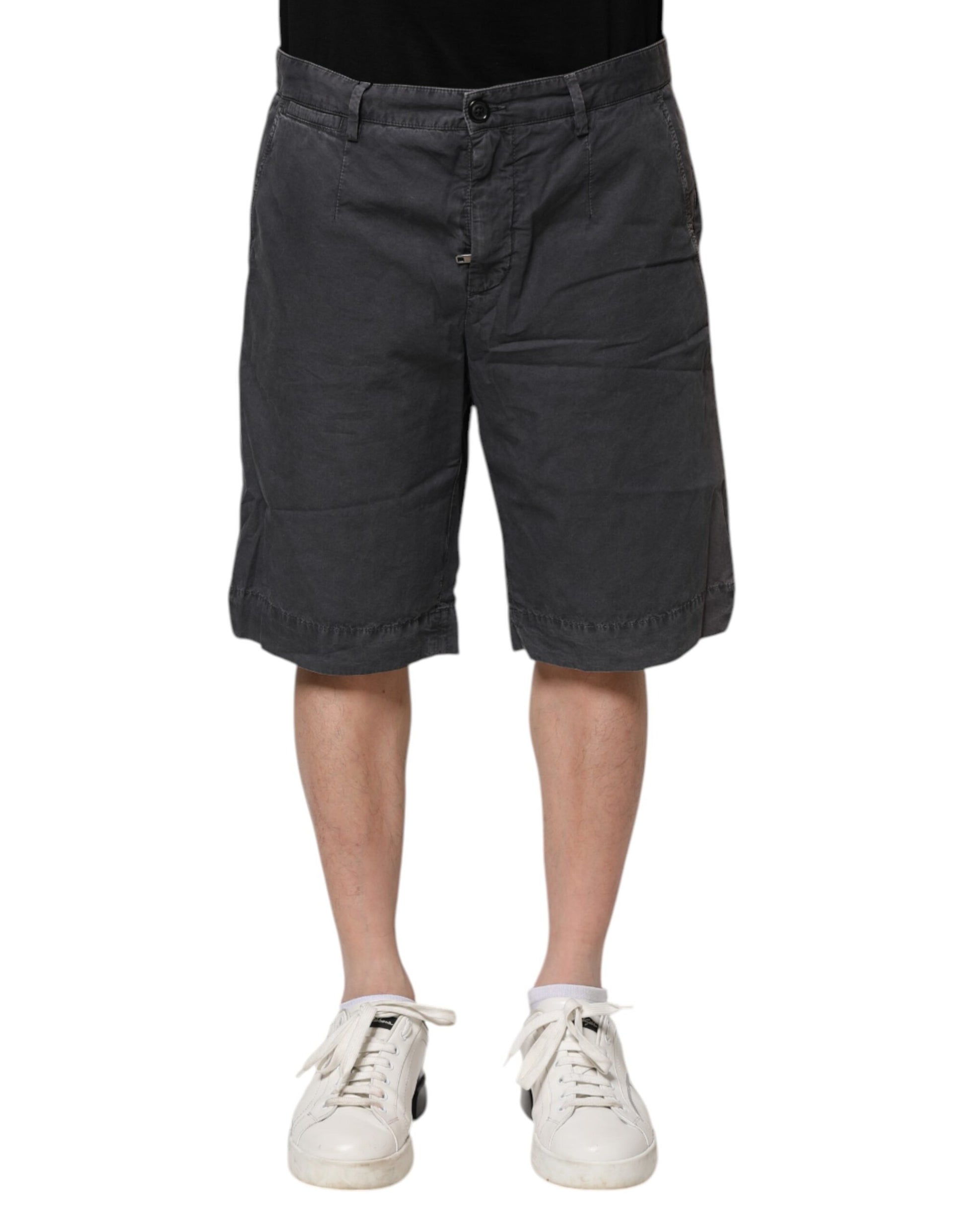 Man wearing black shorts and white sneakers
