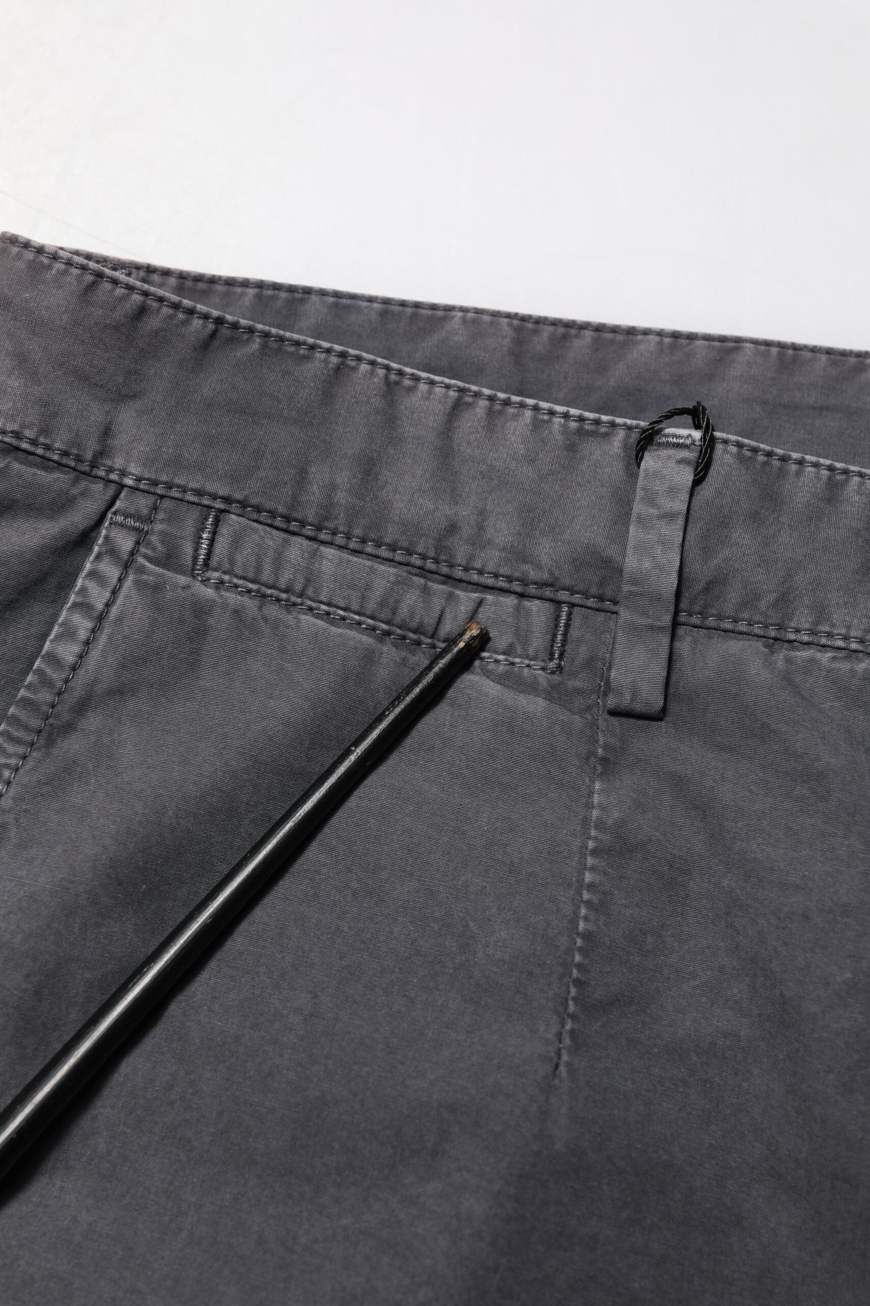 Pair of dark blue jeans with button closure