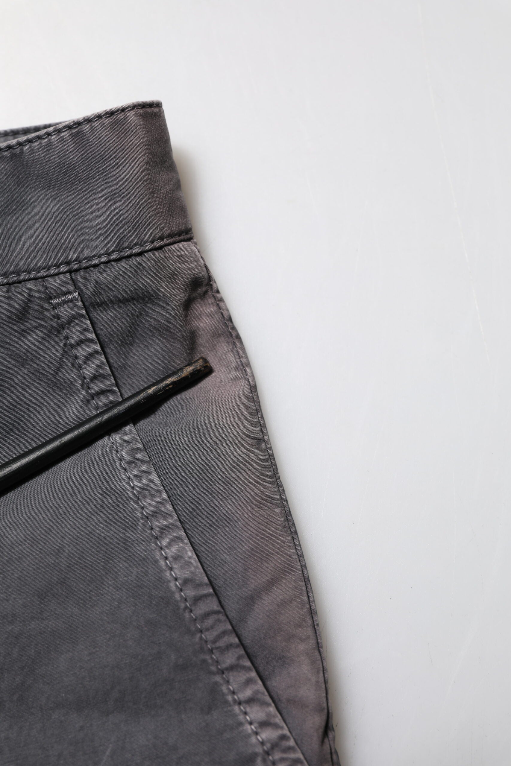 Pair of dark blue jeans on a white surface