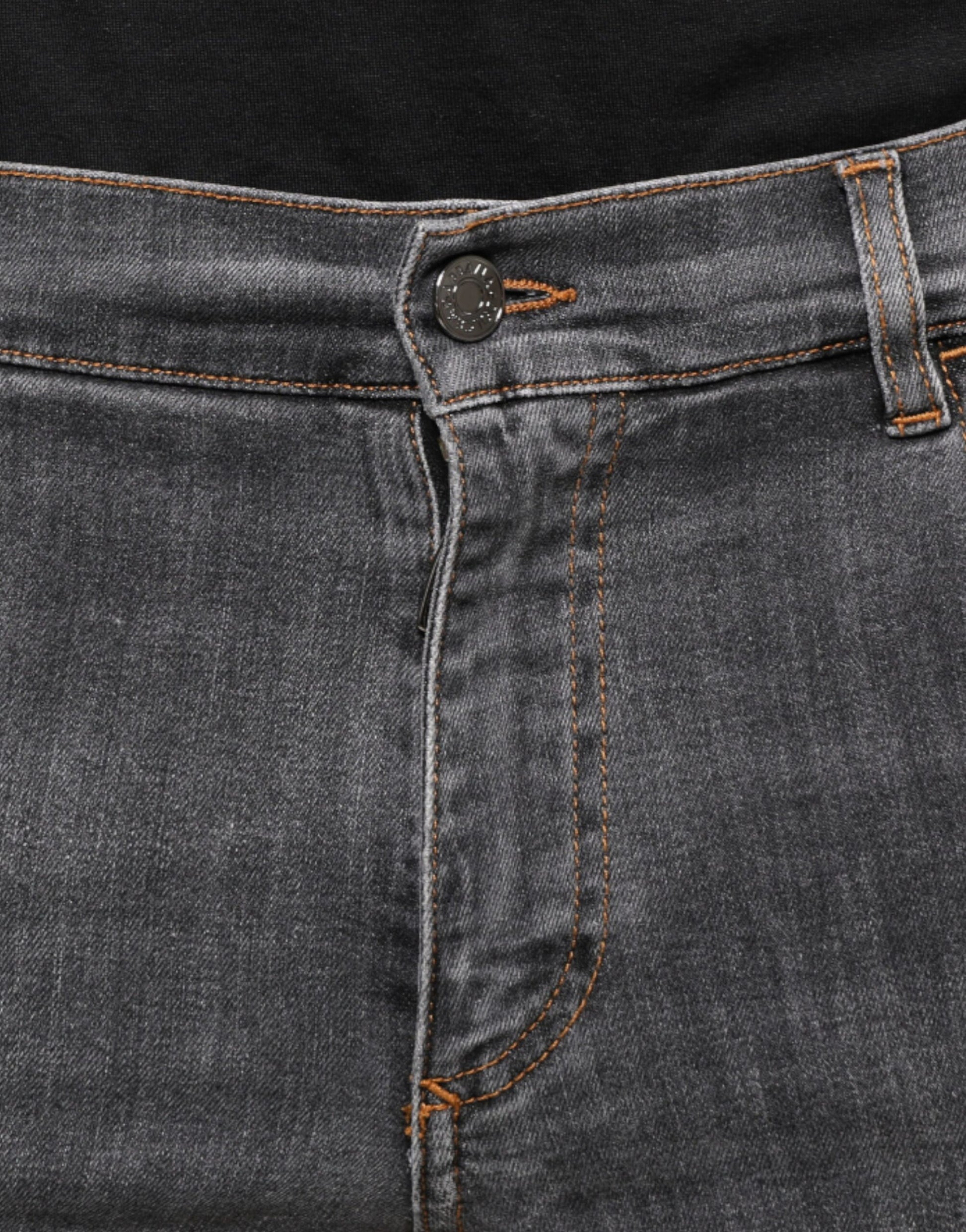 Pair of blue jeans with orange stitching on waistband