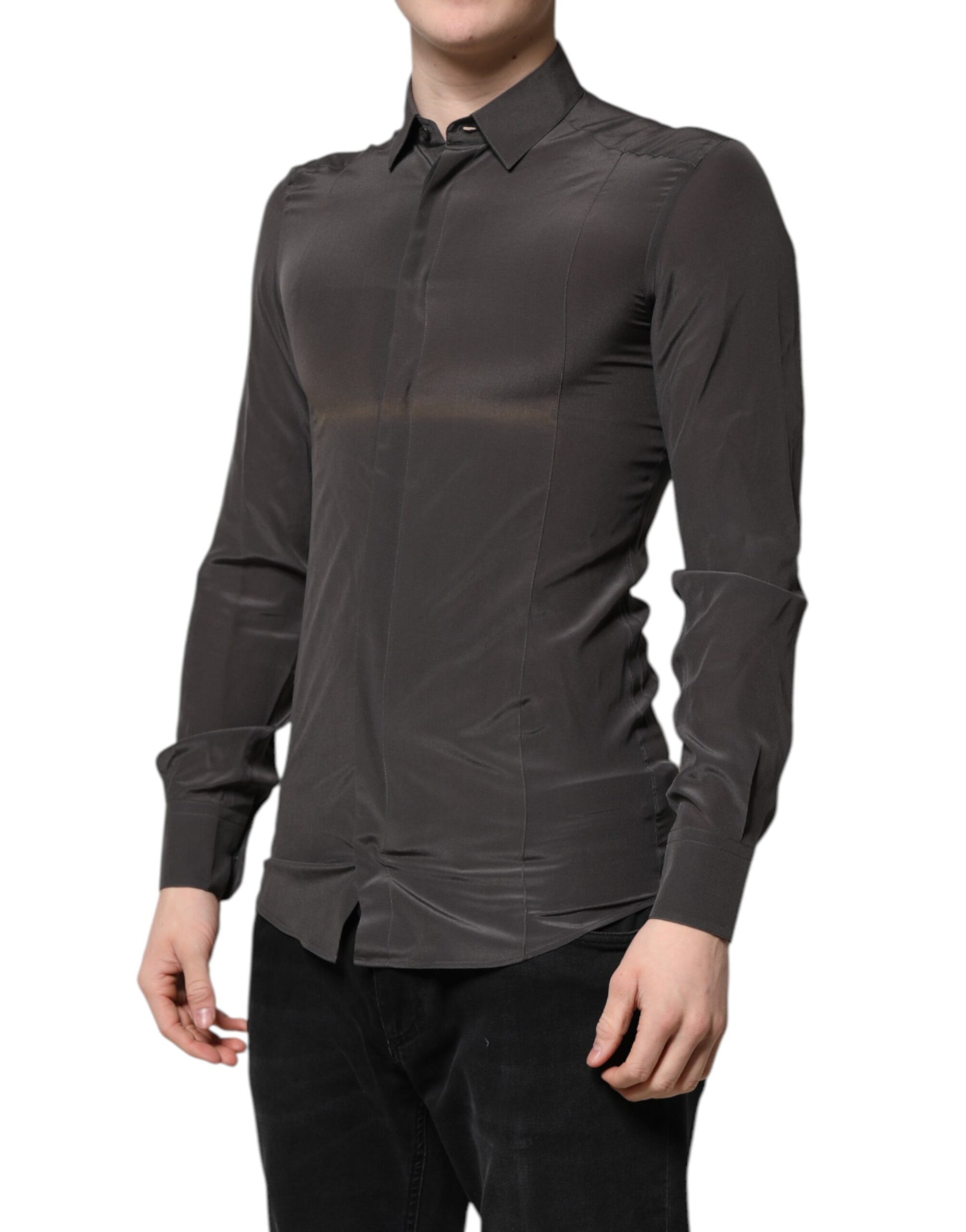 A mannequin wearing a dark gray silk shirt with gold accents, part of the formal wear collection by Dolce & Gabbana