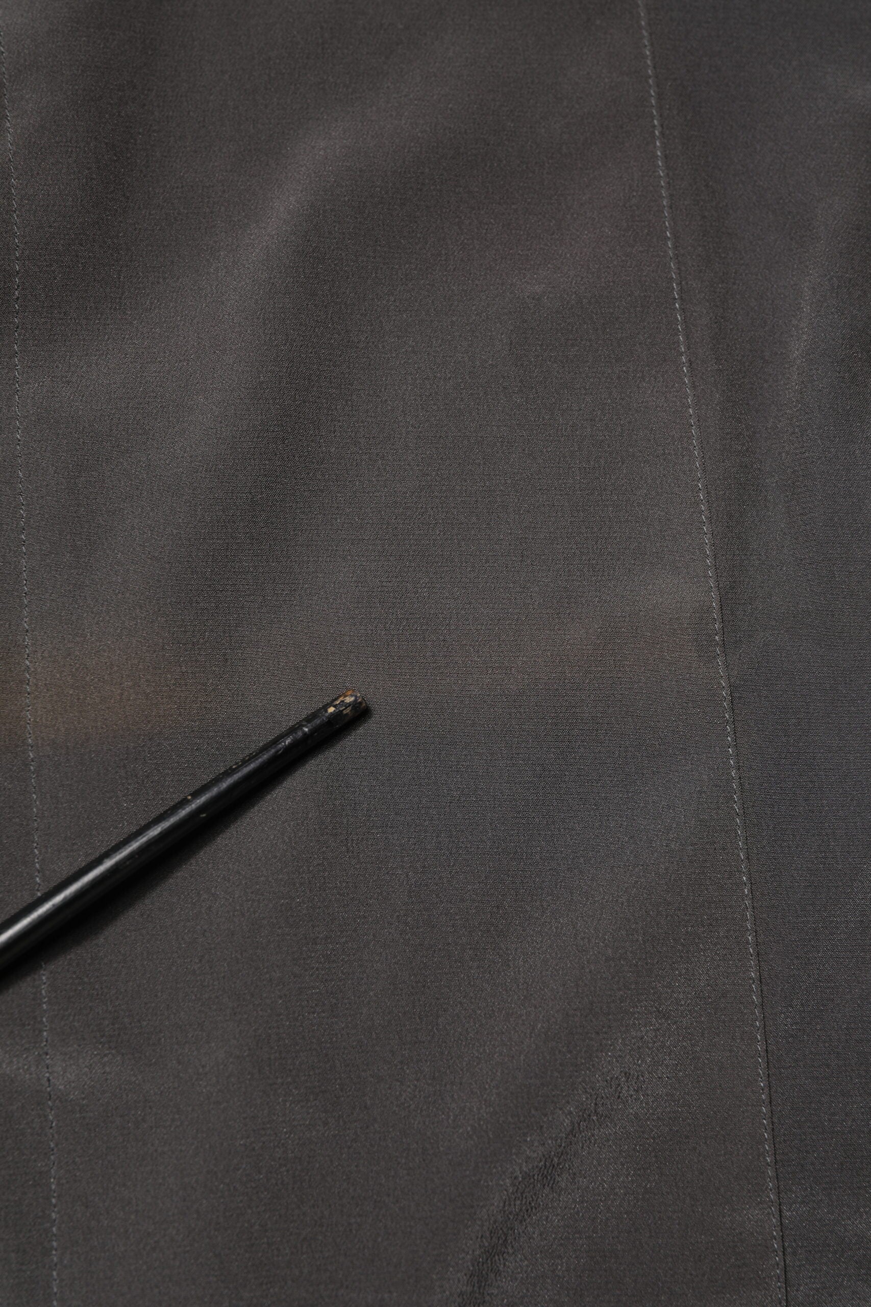 A dark gray silk dress shirt with a gold pattern, part of the formal wear collection by Dolce & Gabbana