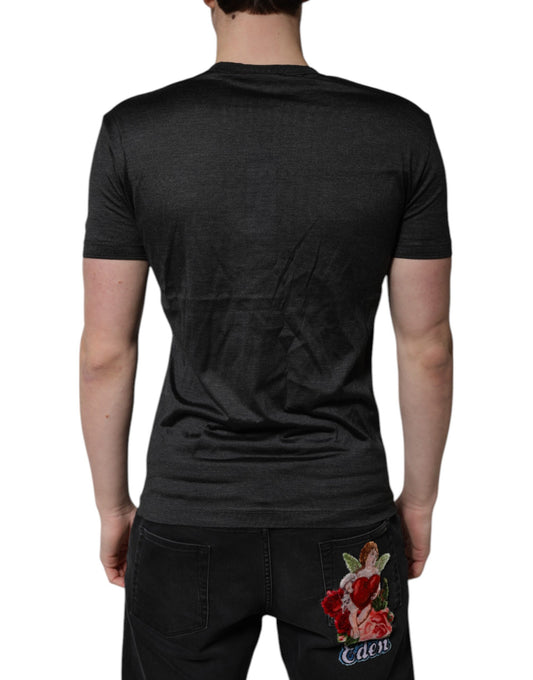 Mannequin torso wearing dark grey t-shirt and black jeans with floral design on back