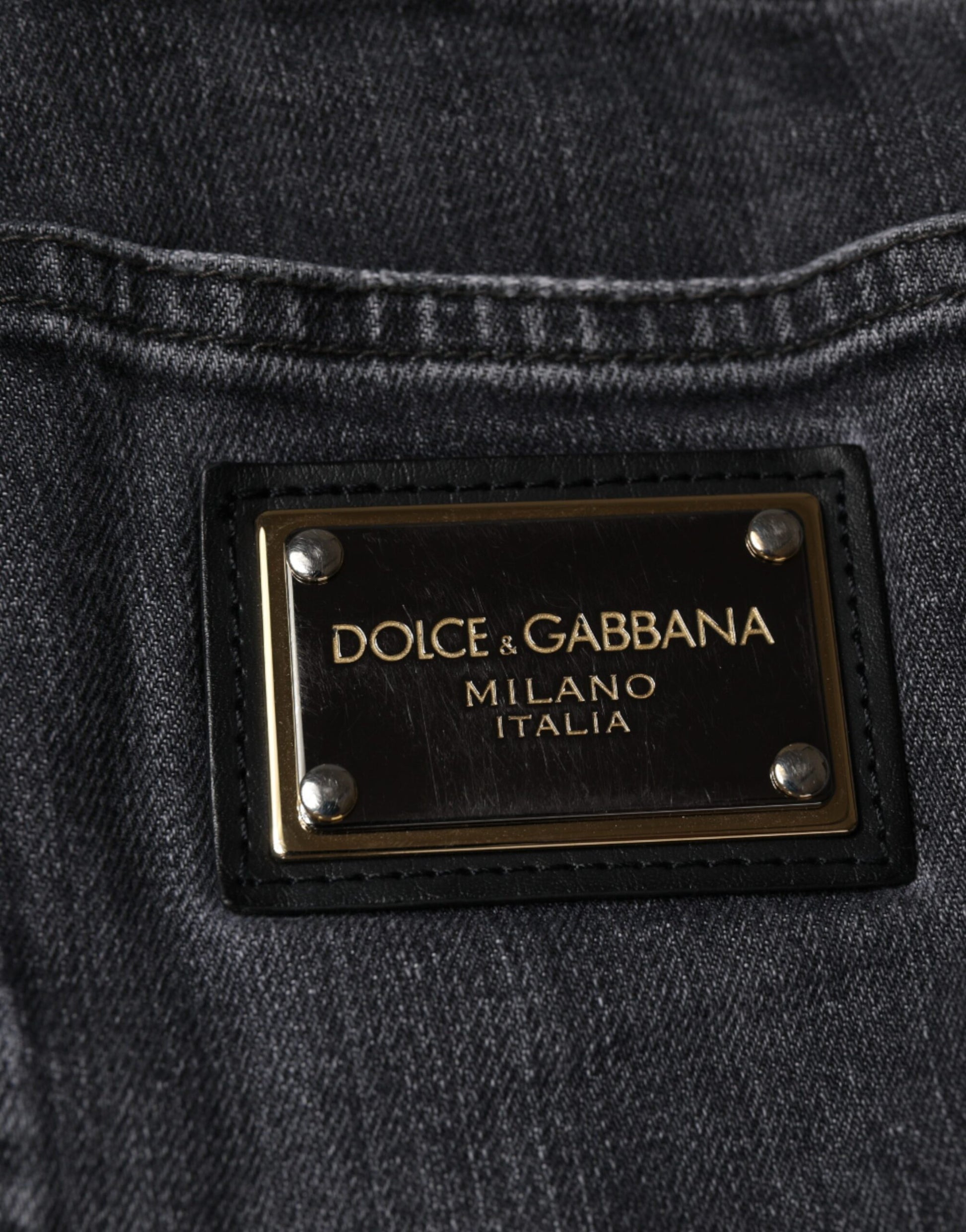 The tag is black with gold lettering