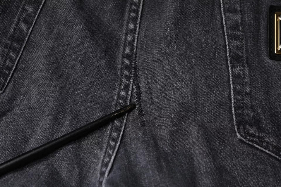 Pair of blue jeans with a hole in the knee area