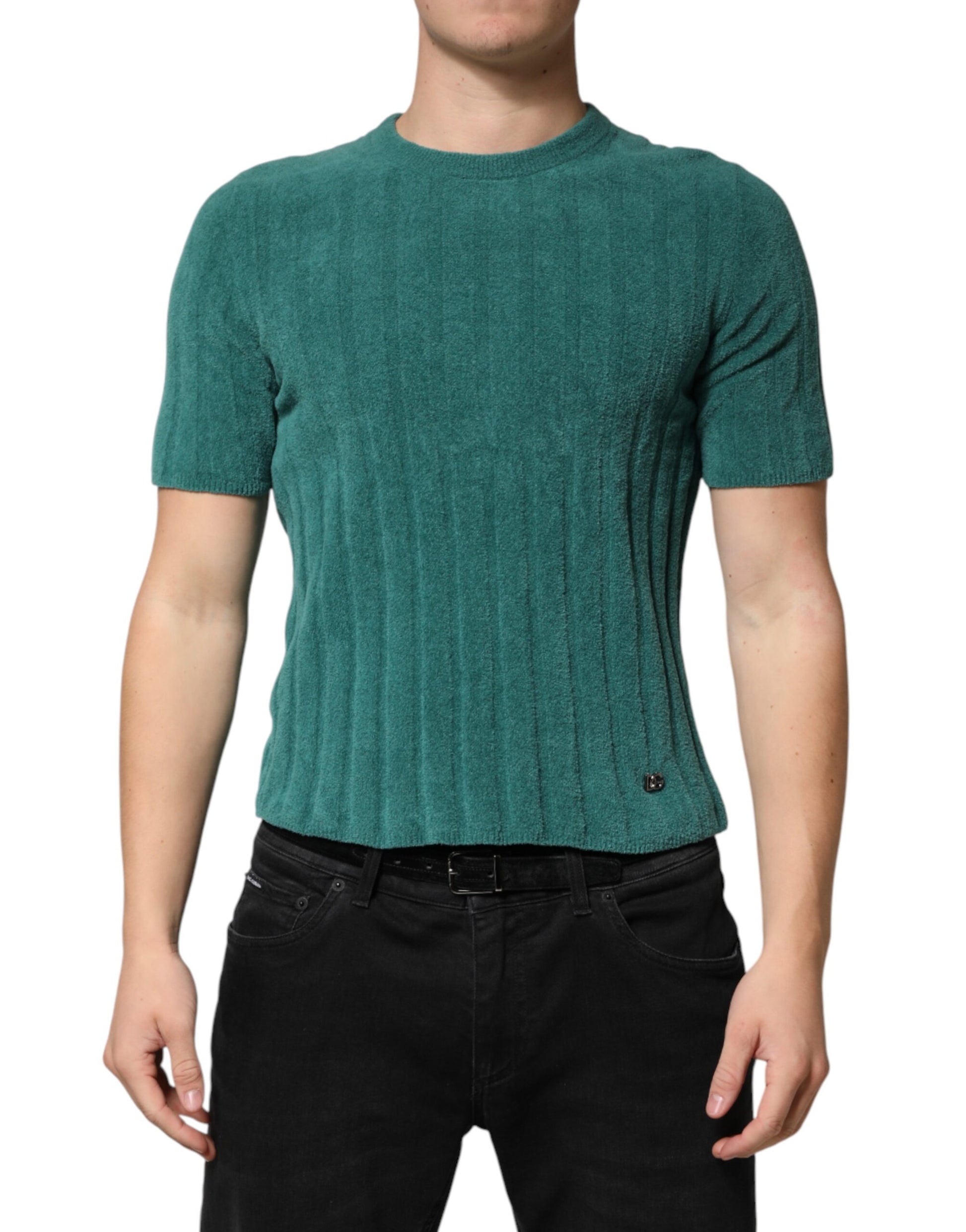 Man wearing a green sweater vest over black pants