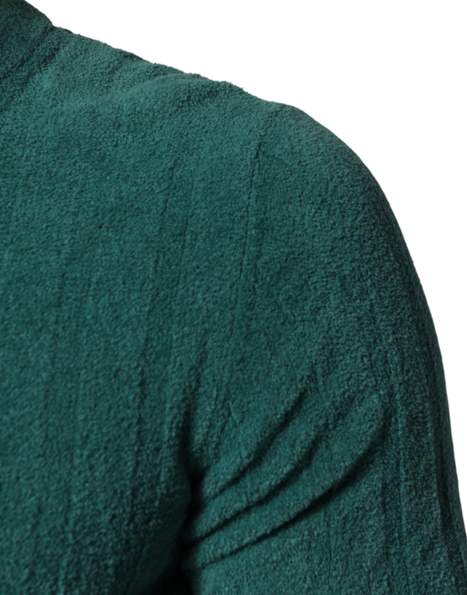 A person wearing a dark green sweater