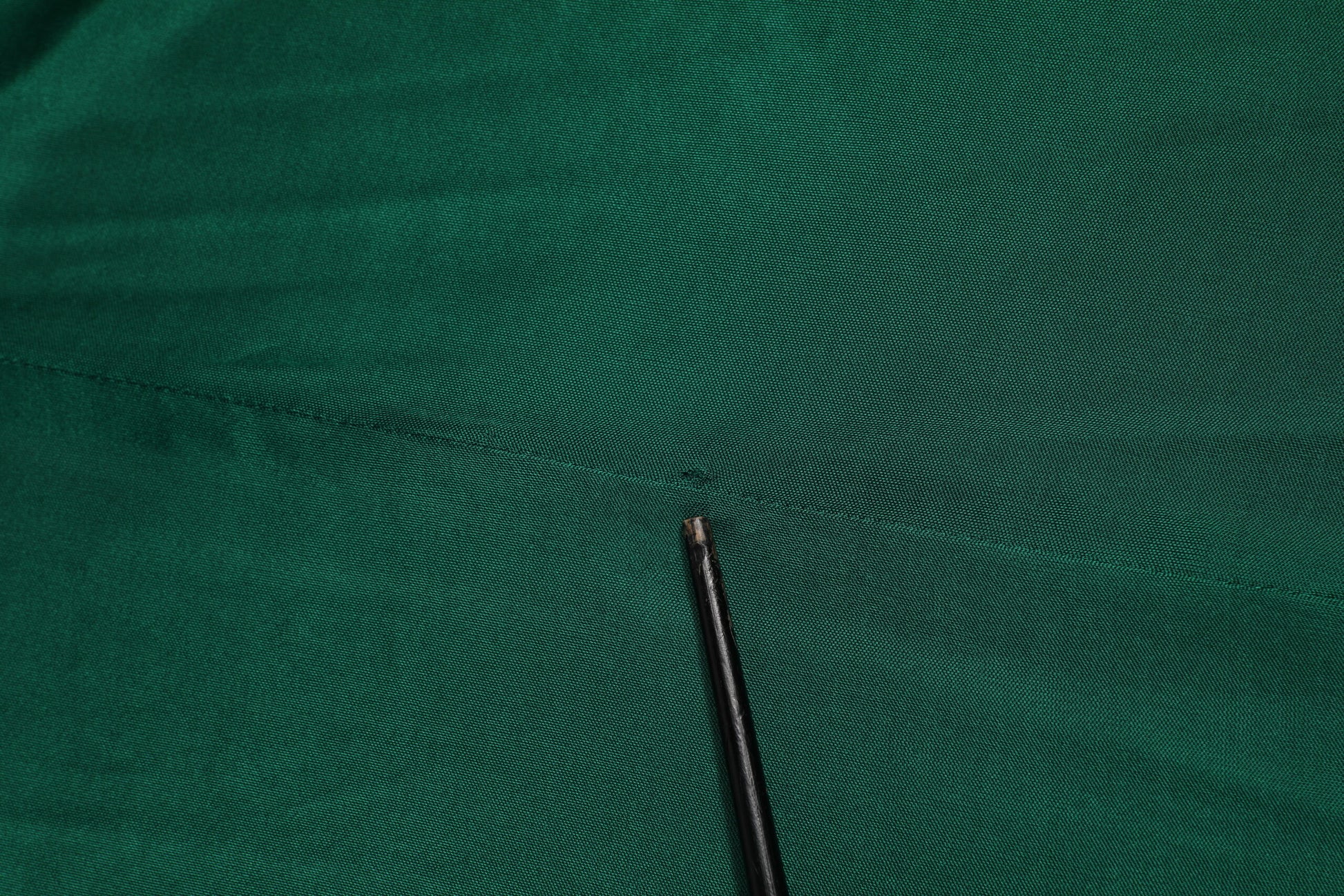 Black needle on green fabric