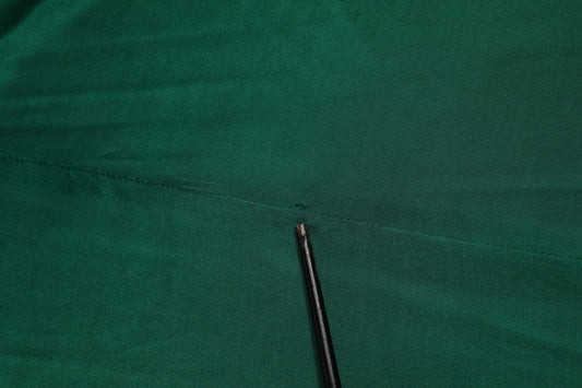 Black needle on green fabric
