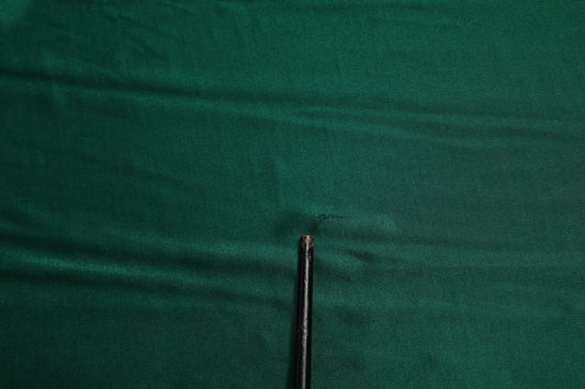 Black needle on green fabric