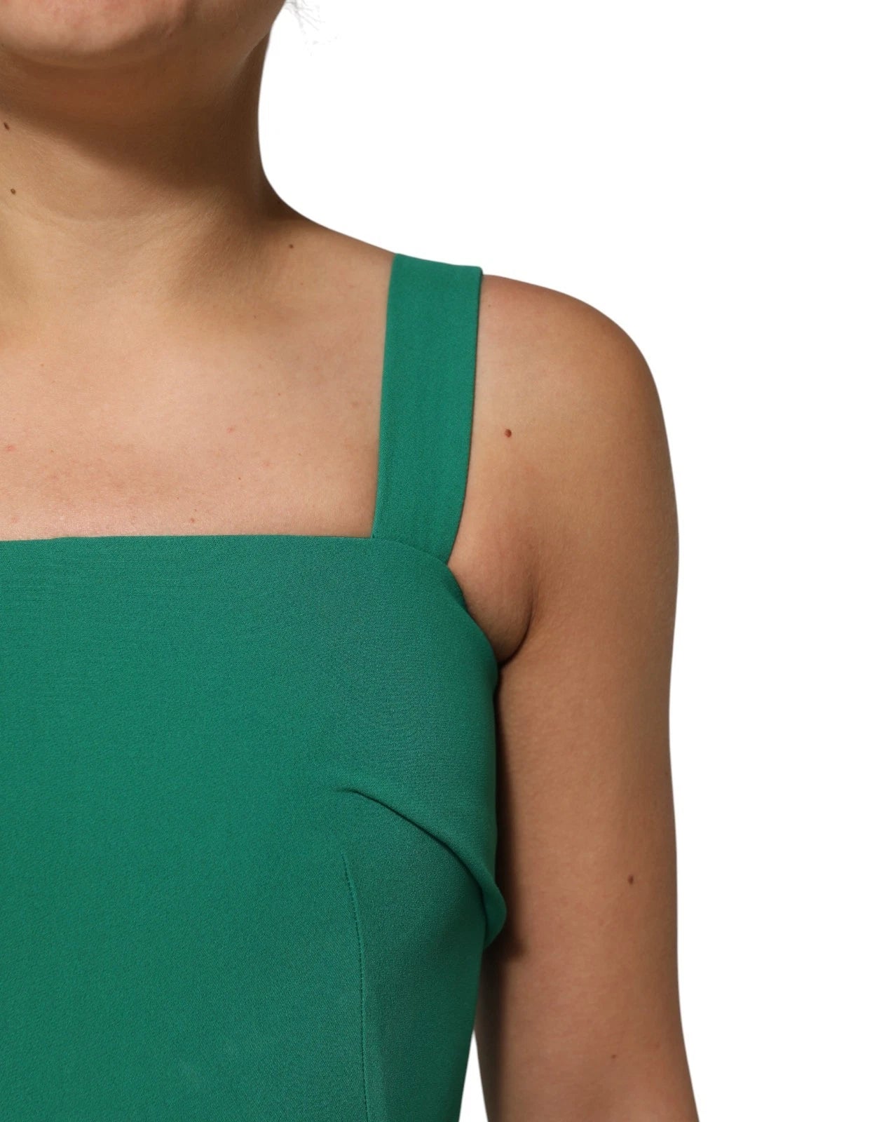 A sleeveless, dark green bodycon dress with a V-neckline