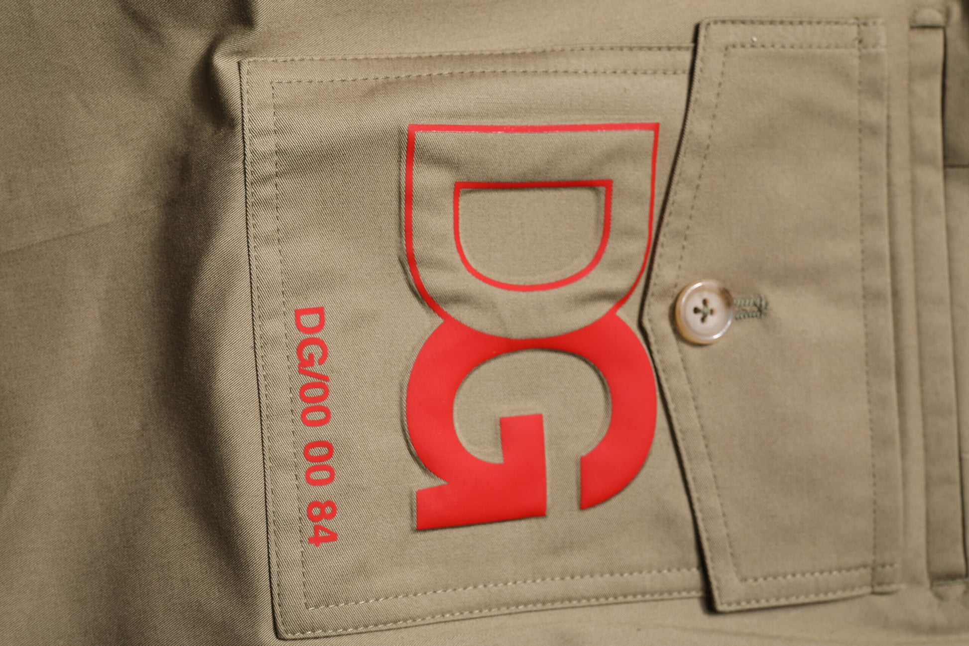 Tan cargo pants with red logo on front