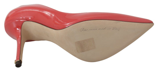 Red high heel shoe with a brown sole and a red bow on top