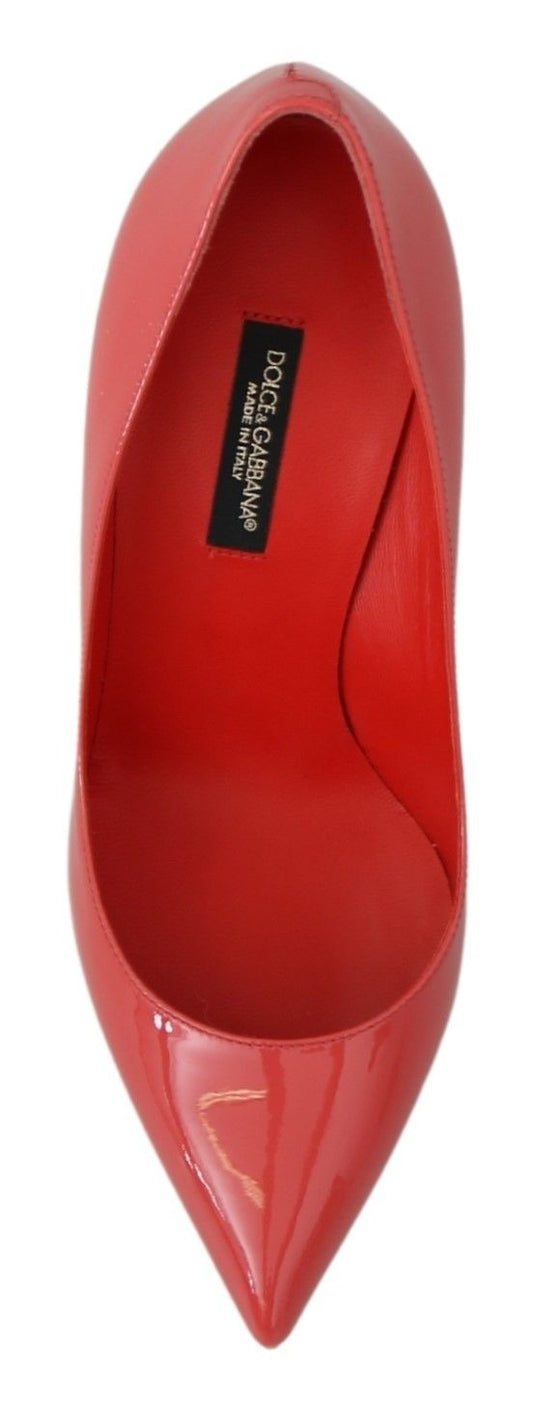 Red high heel shoe with pointed toe and black label on inside