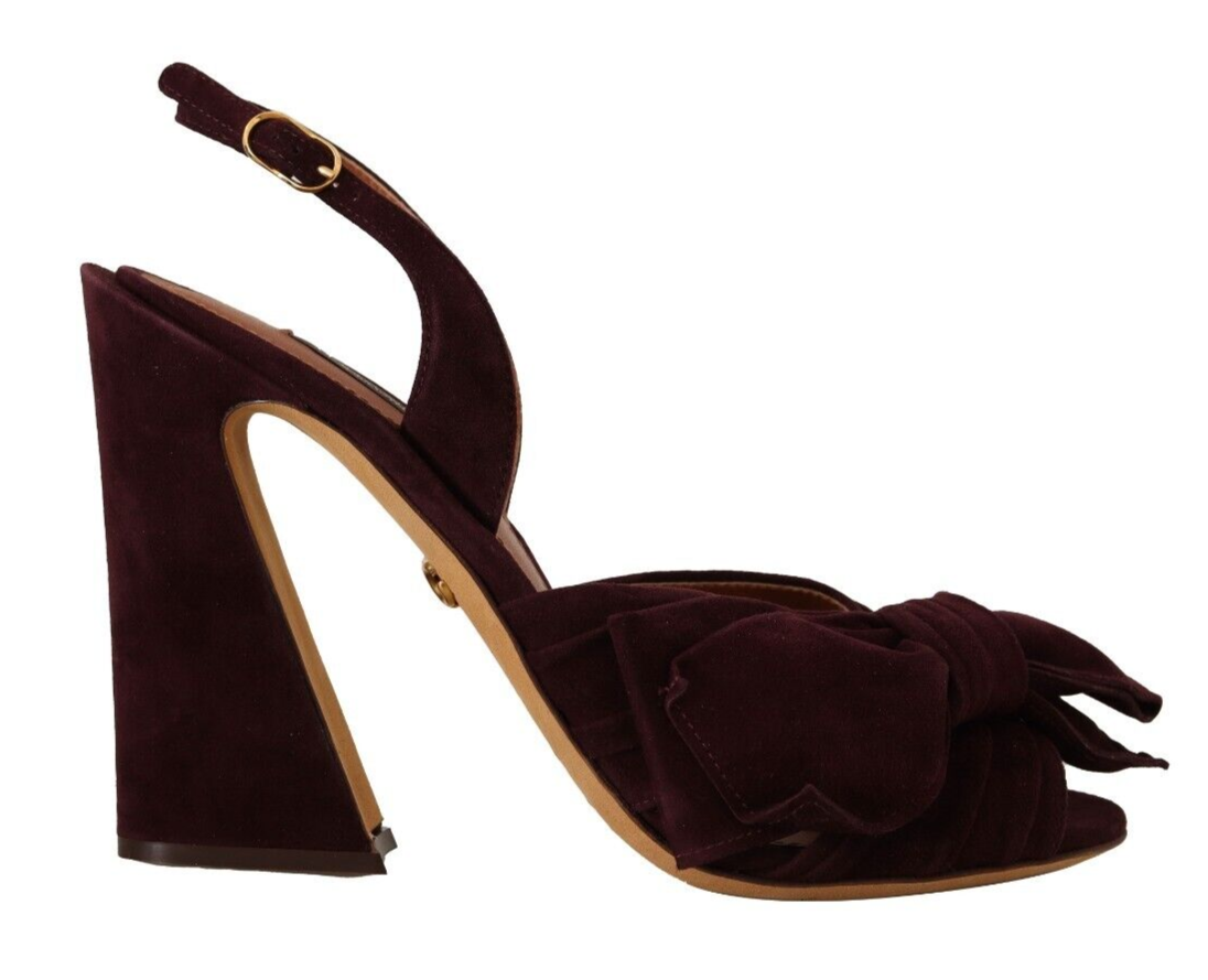 A single shoe against a white background. It is a high heel sandal with a velvet texture in a dark color, possibly burgun