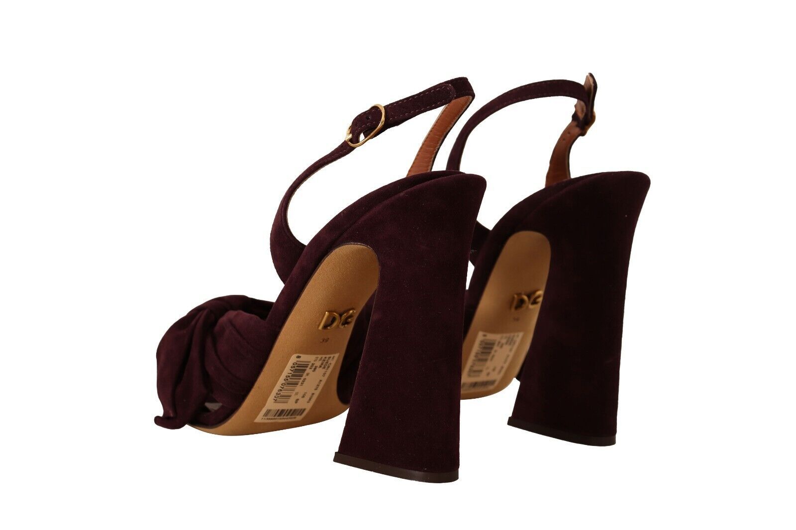 Pair of high heel shoes with brown straps and a label on the insole