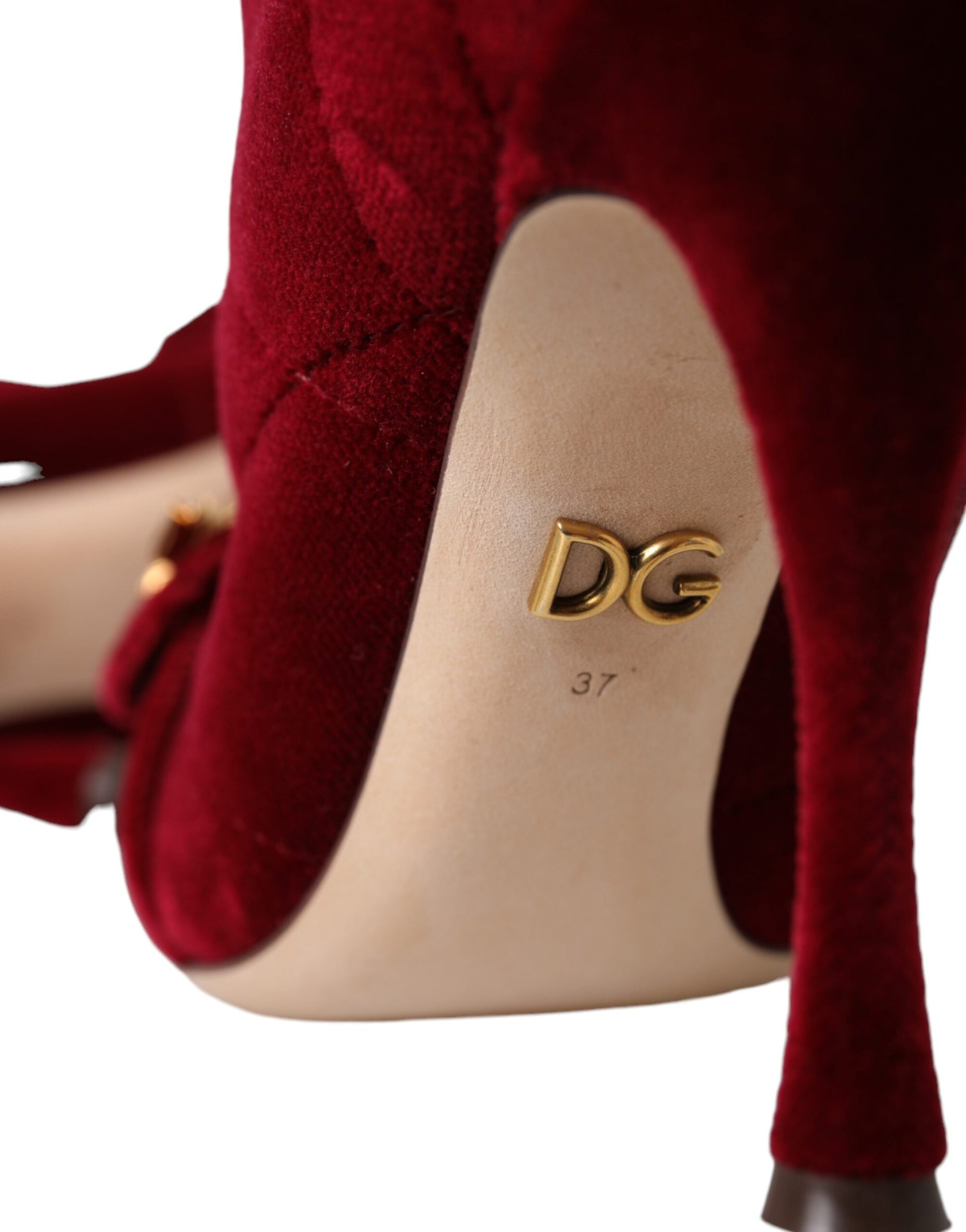 Red high heel shoe with gold logo on insole