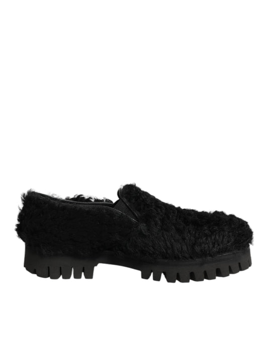 A pair of black fur-lined leather shoes with a chunky sole, designed by Dolce & Gabbana