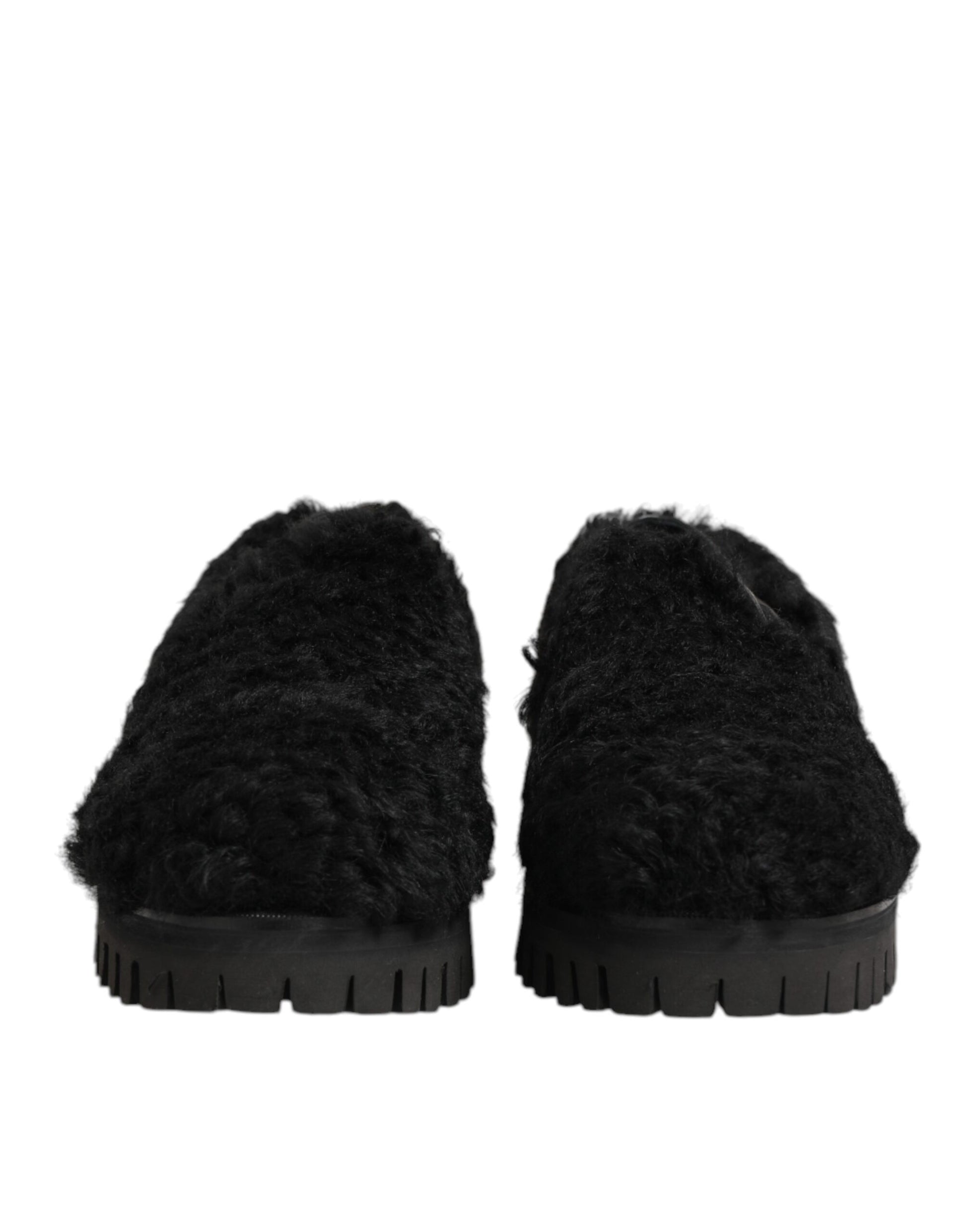 Pair of black fur lined leather slippers with rubber soles, designed for men